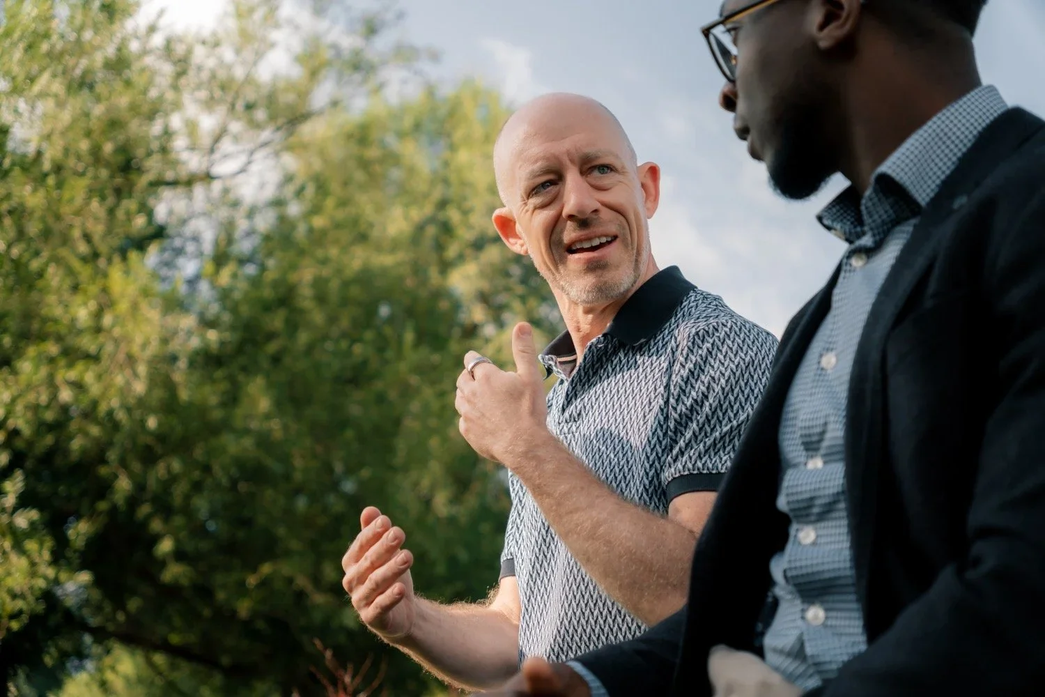 John listening during a coaching conversation outdoors
