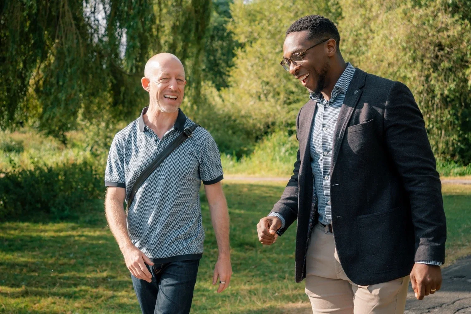 John walking and talking with a coaching client in nature